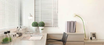 Modern office space with windows, desk and chair